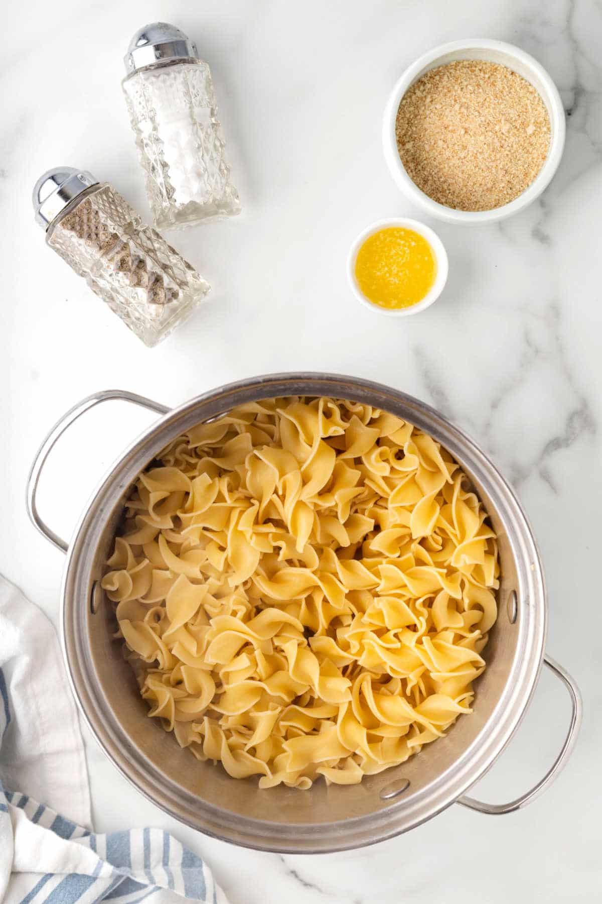 A pot of cooked egg noodles.