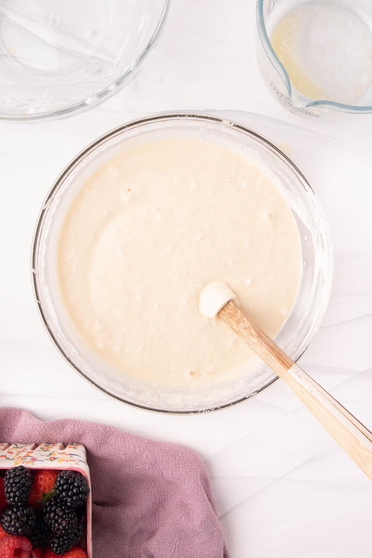 Waffle batter in a glass mixing bowl. 