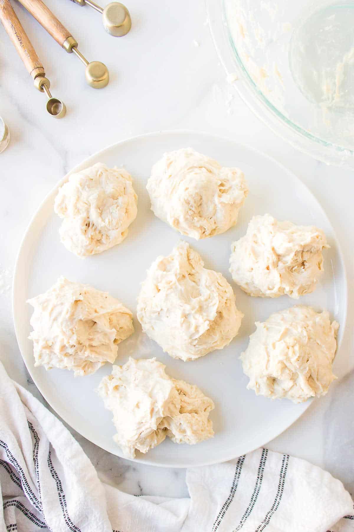 Pieces of fry bread dough on a white plate. 