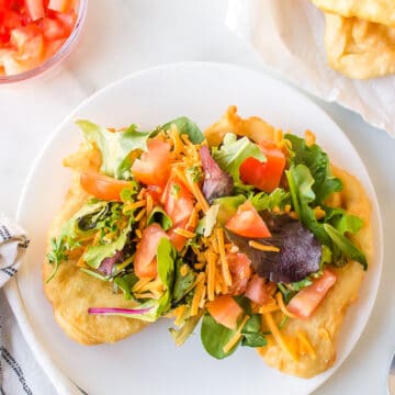 Fry bread topped with lettuce cheese and tomatoes.