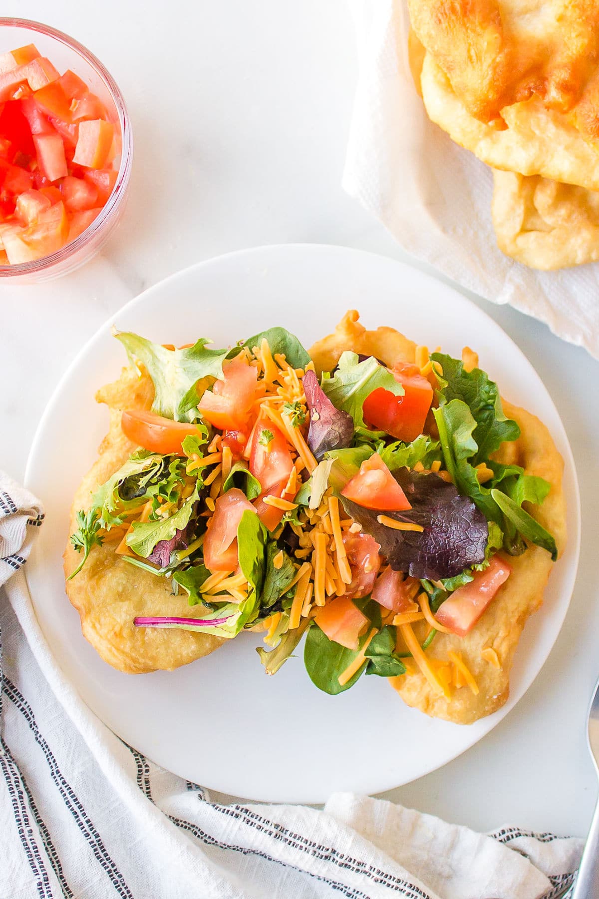 Fry bread topped with lettuce cheese and tomatoes.