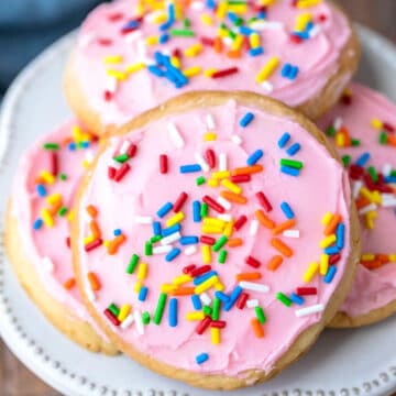 Pink frosted Lofthouse cookie copycats on a cream plate.