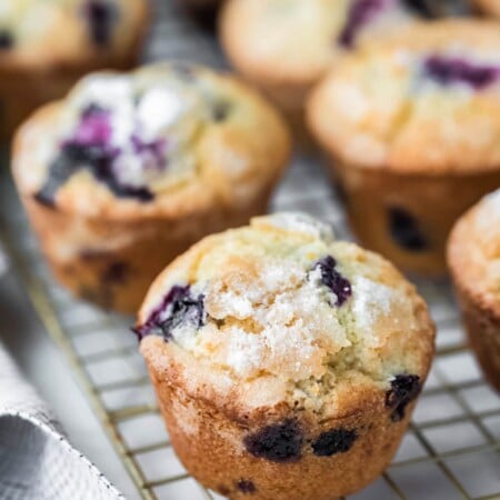 Lemon blueberry muffins next to a checkered linen.