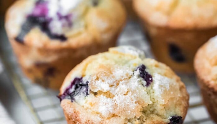 Lemon blueberry muffins next to a checkered linen.