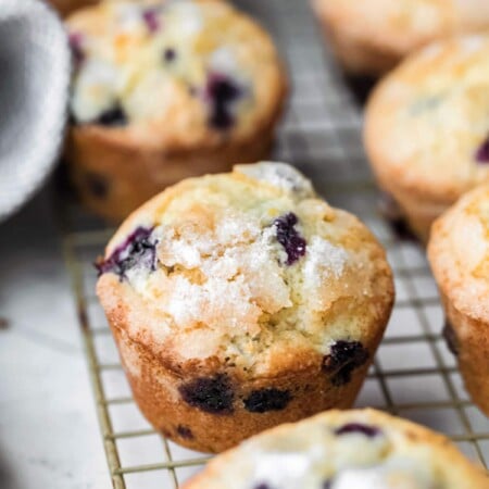 Lemon blueberry muffins on a wire cooling rack.