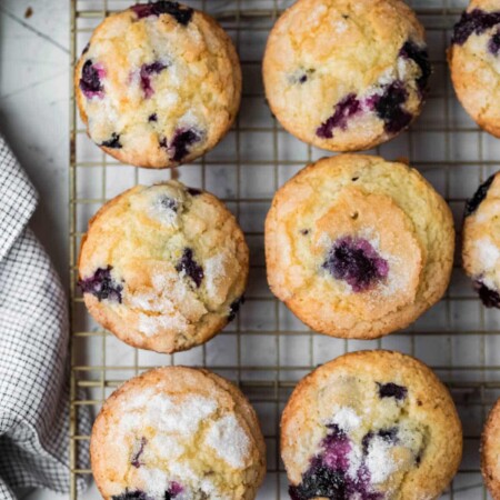 Overhead photo of lemon blueberry muffins on a wire cooling rack.