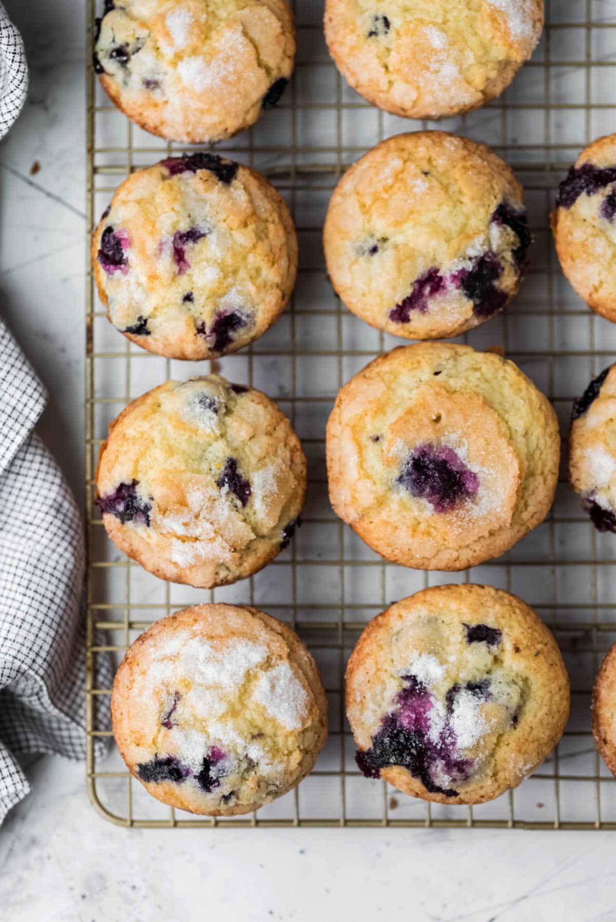 Overhead photo of lemon blueberry muffins on a wire cooling rack. 