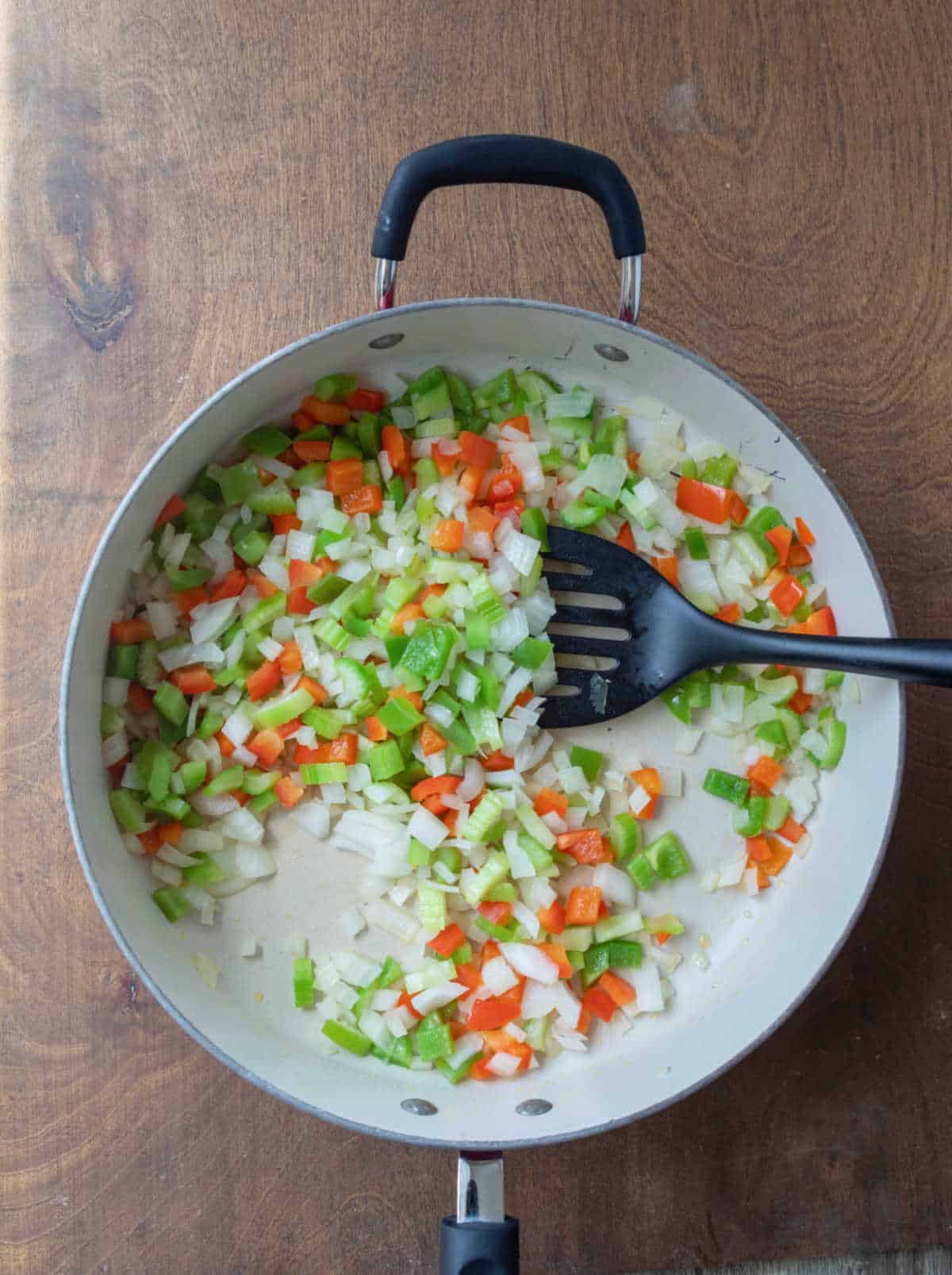 Vegetables cooking in a large skillet. 