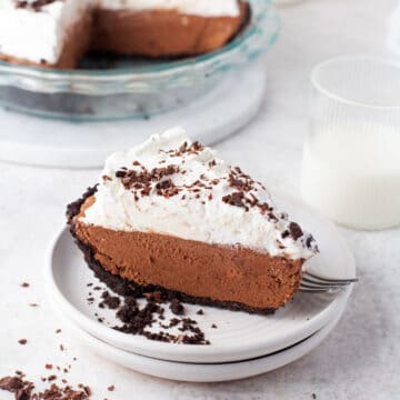 A slice of chocolate no bake pie on a white plate.
