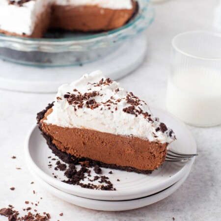 A slice of chocolate no bake pie on a white plate.