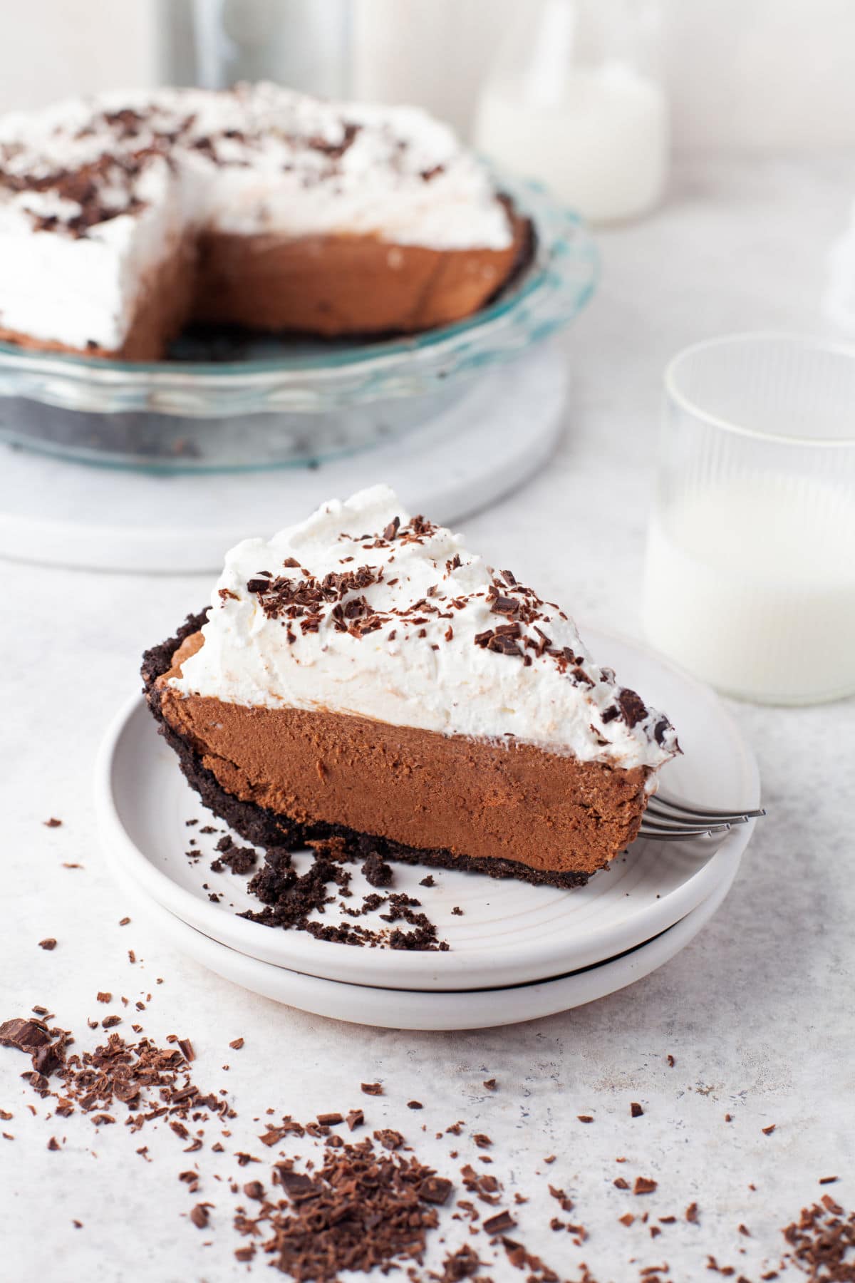 A slice of chocolate no bake pie on a white plate. 