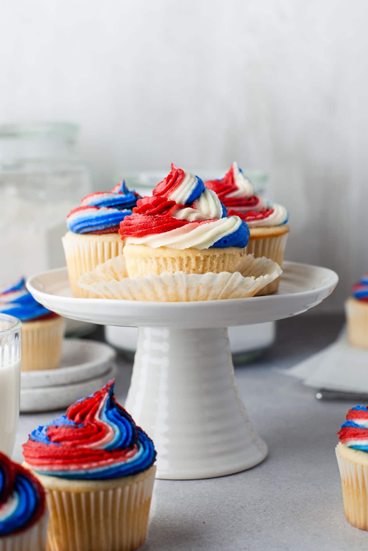red white and blue cupcakes on a white cake stand.