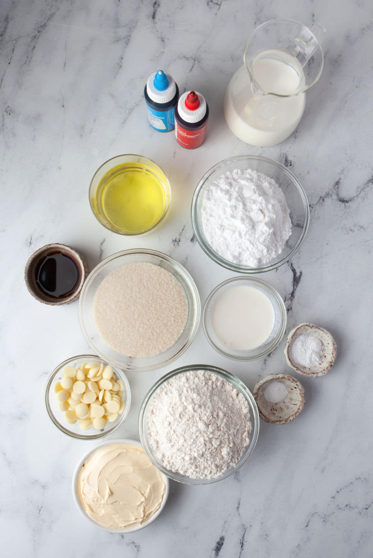 Ingredients for red white and blue cupcakes in dishes.