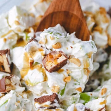 A wooden spoon scooping up snickers salad.