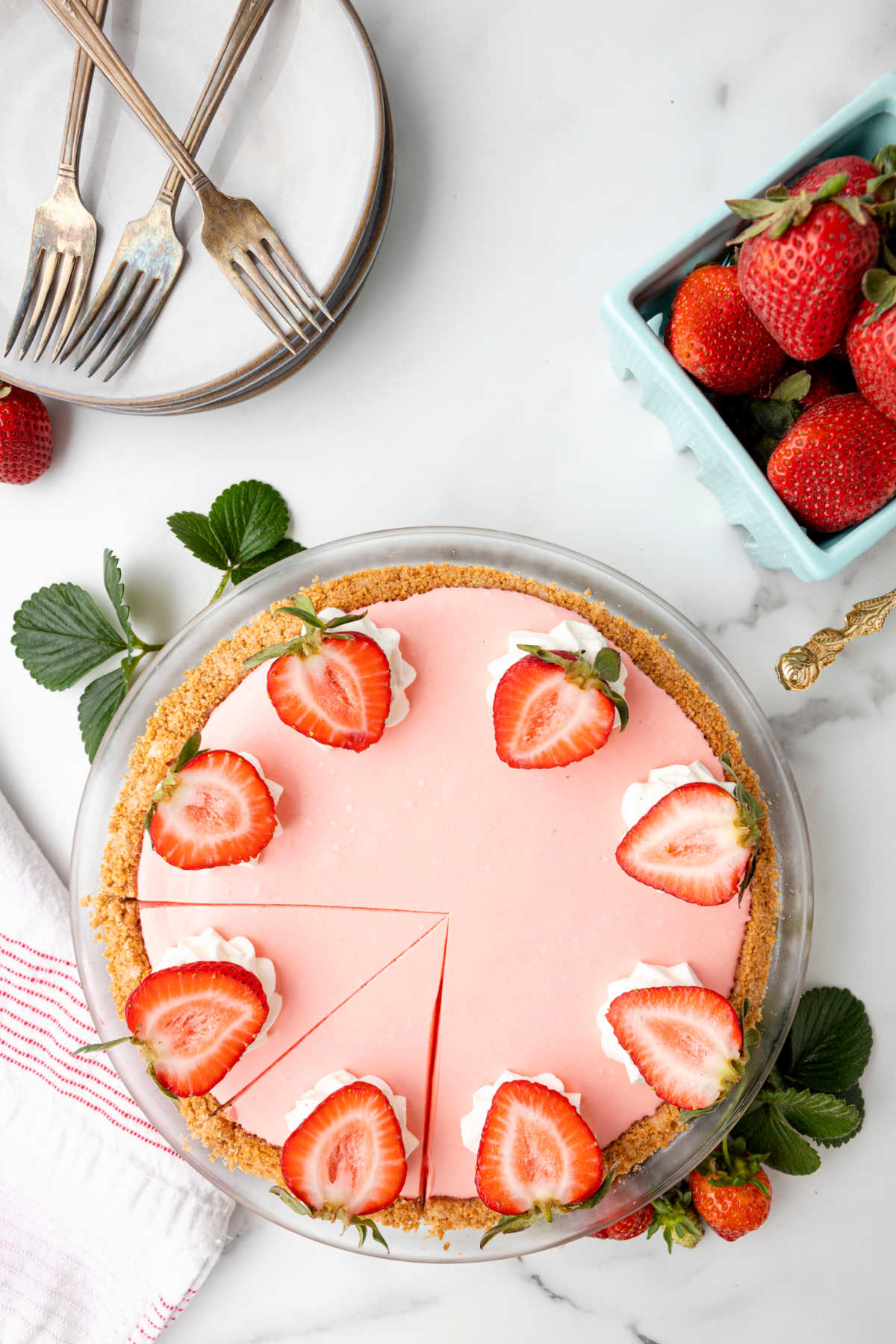 Strawberry jello pie with two slices cut in it. 