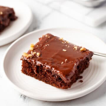 A slice of Texas sheet cake on a white plate.