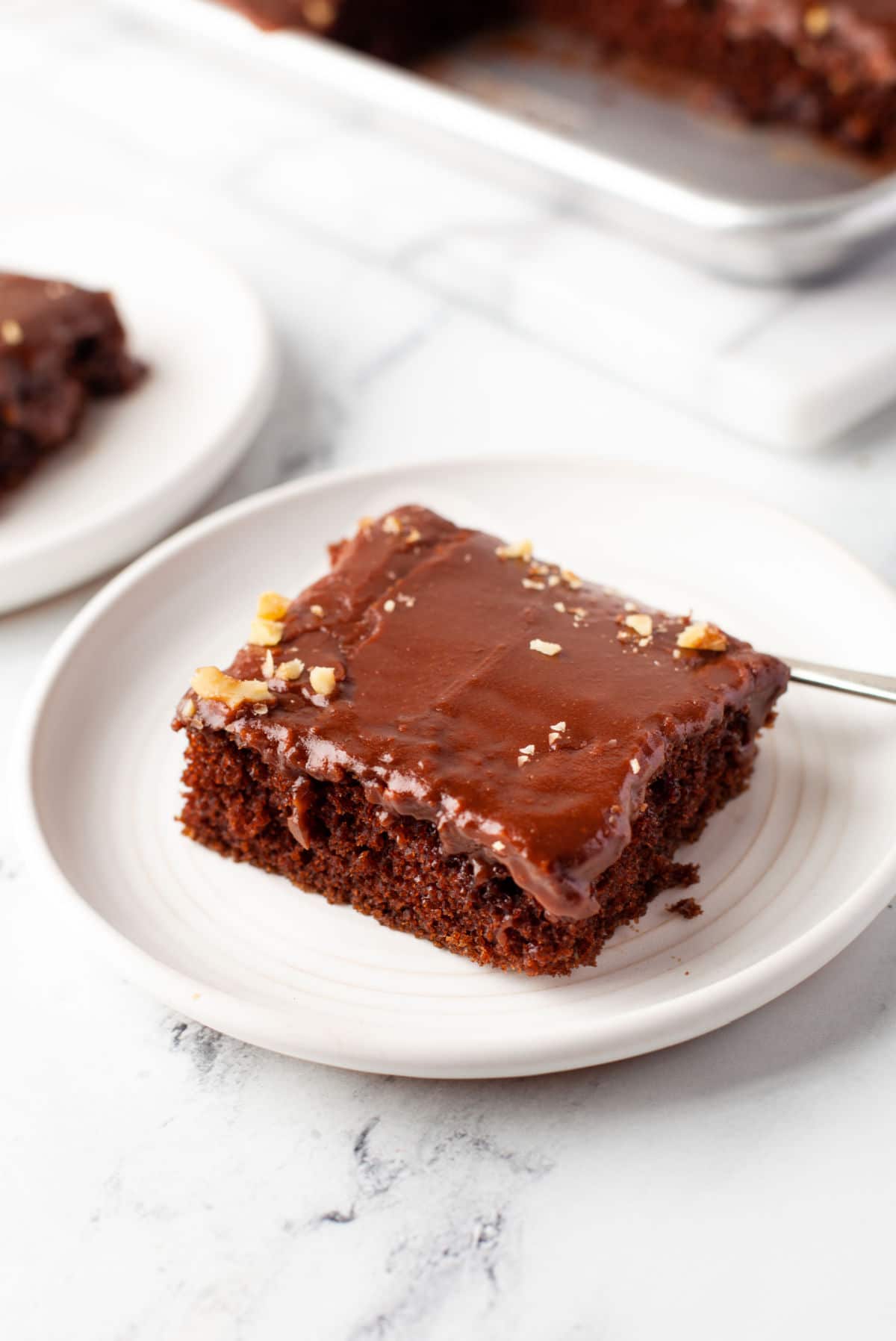 A slice of Texas sheet cake on a white plate.