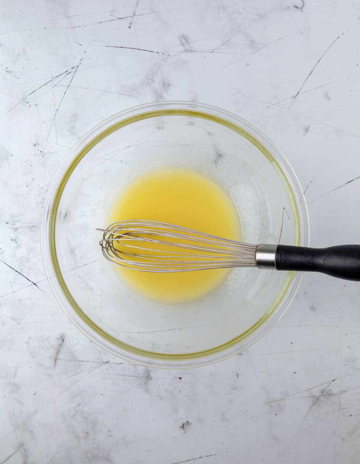 Melted butter in a glass mixing bowl. 