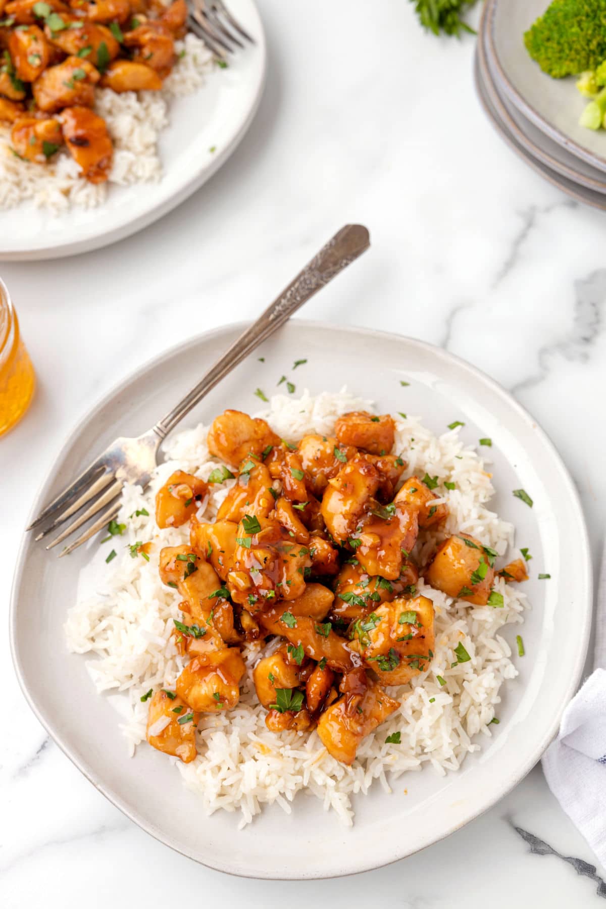 A plate of honey garlic chicken over rice. 