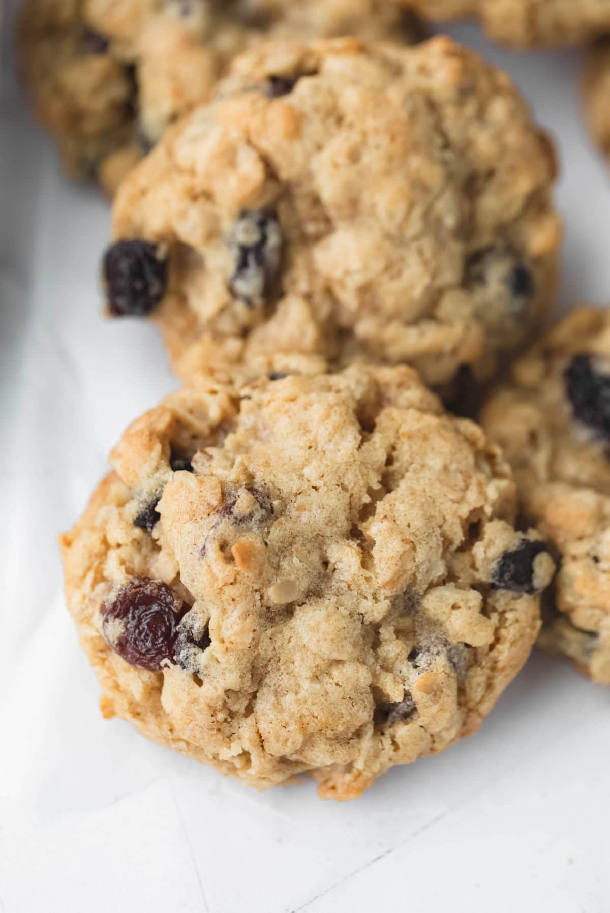 Oatmeal raisin cookies on a piece of parchment paper. 