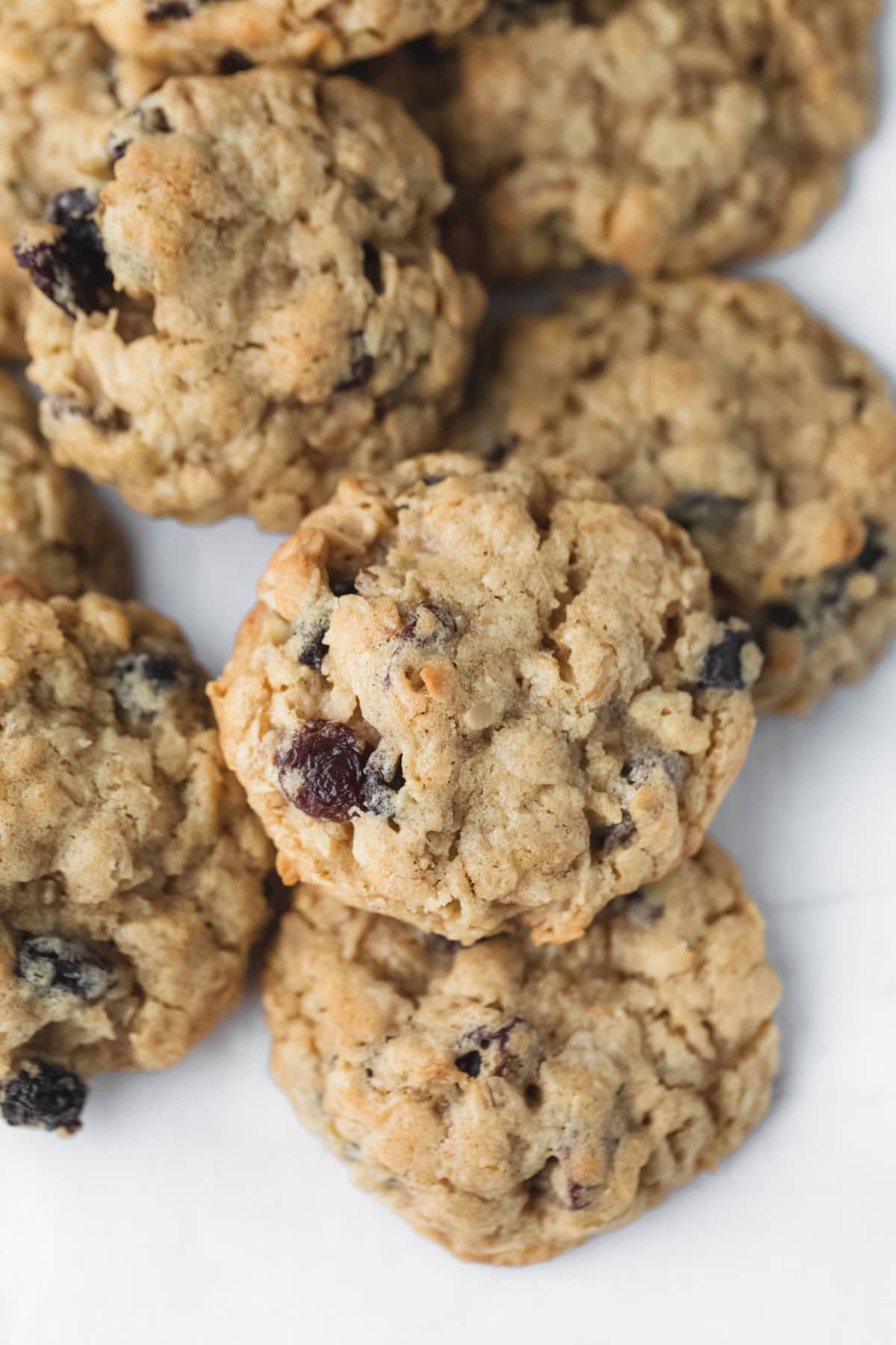 Oatmeal raisin cookies in a stack on top of each other. 