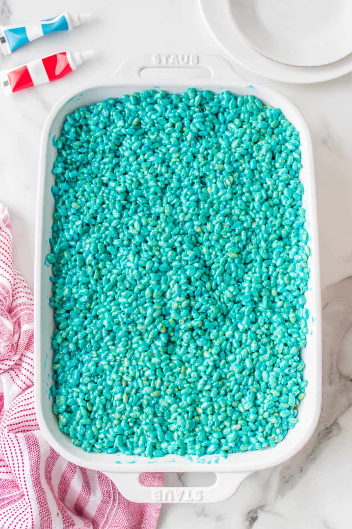 Blue rice krispies in a pan.