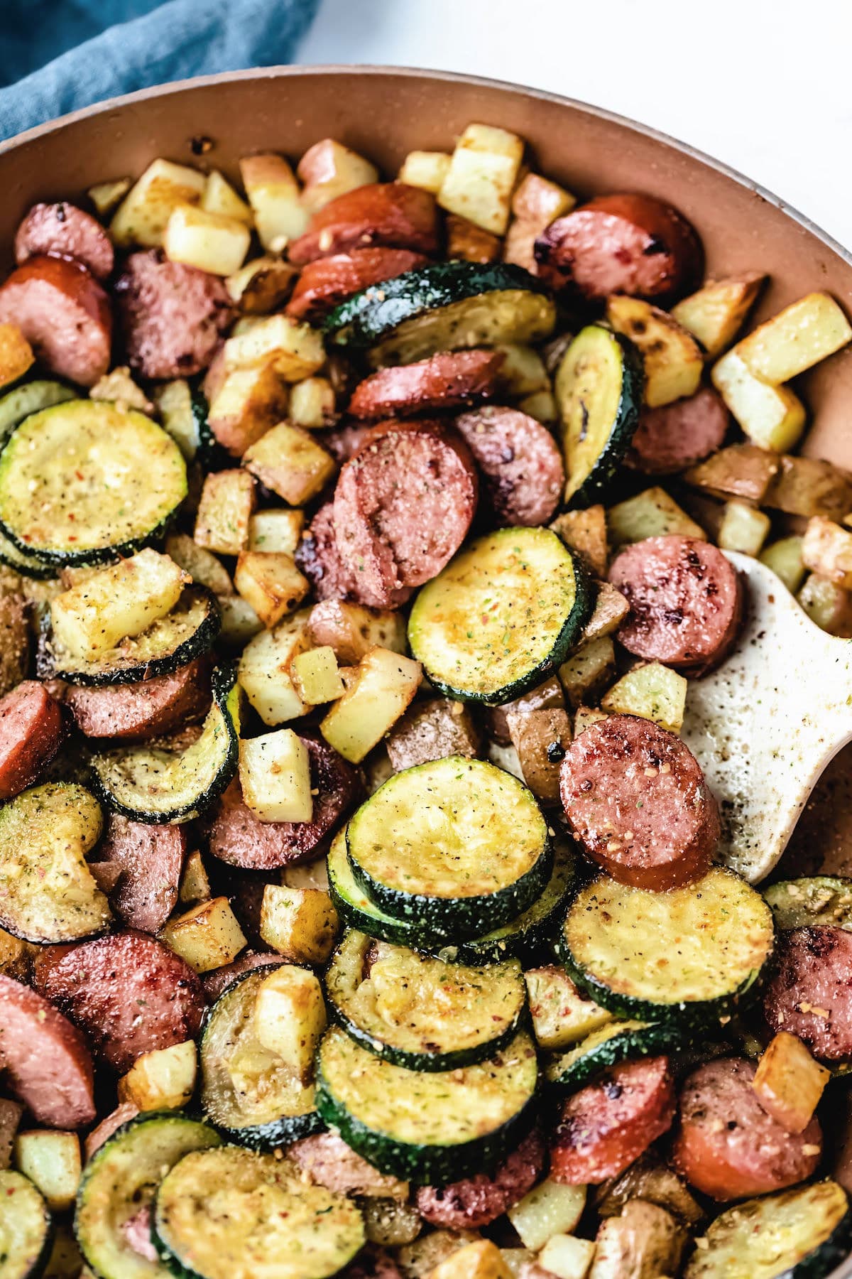 Kielbasa zucchini and potatoes in a skillet.