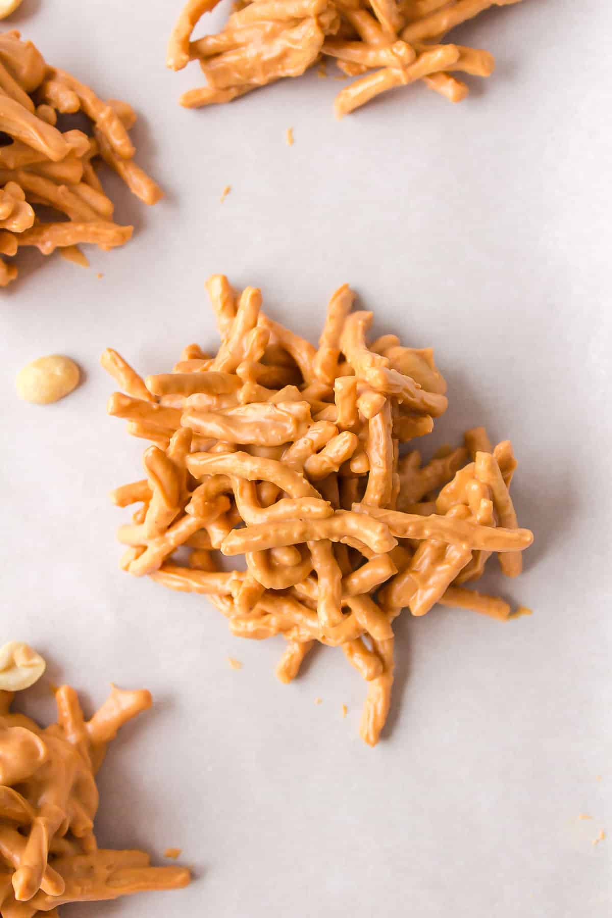 A haystack cookie on a piece of parchment paper.