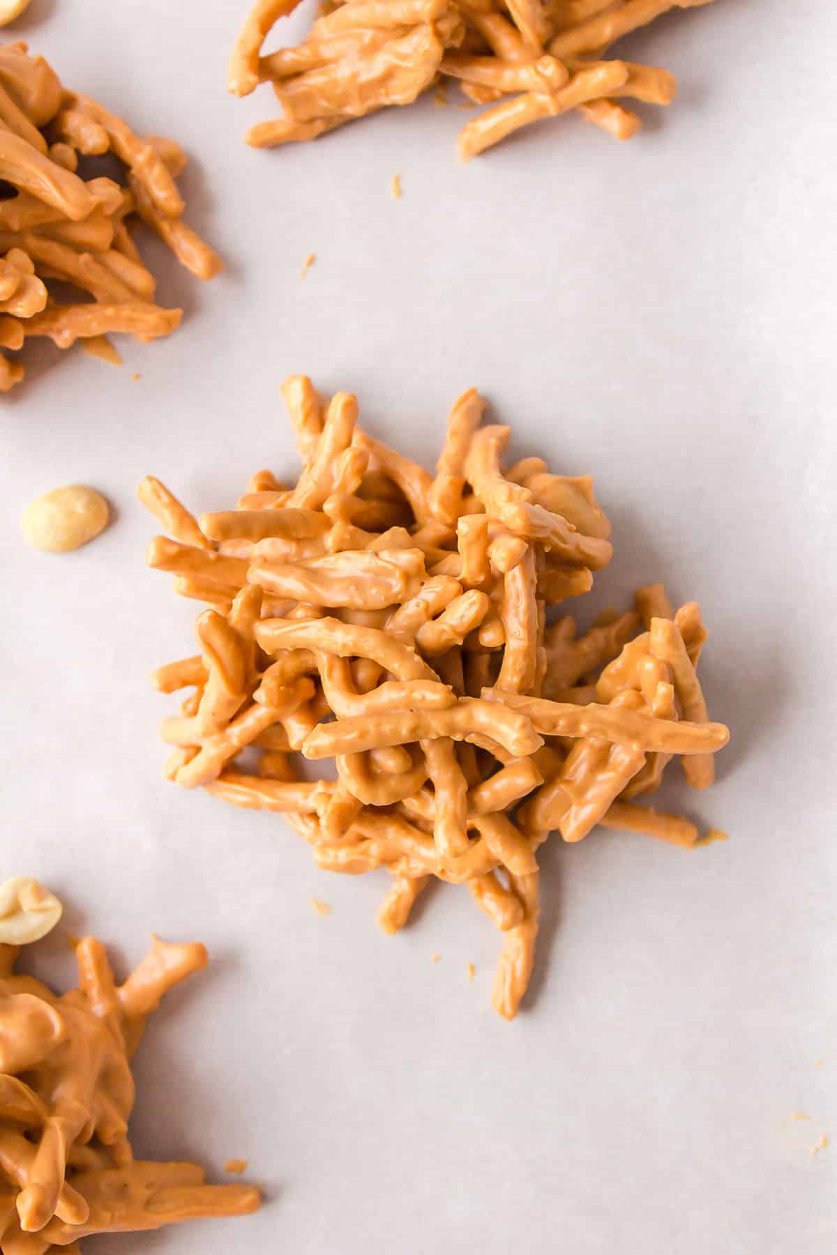 A haystack cookie on a piece of parchment paper. 