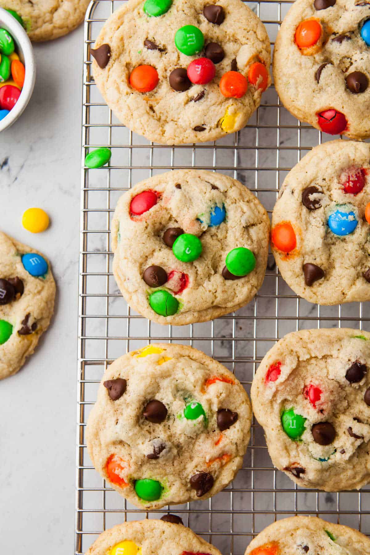 M&M cookies on a wire baking sheet. 