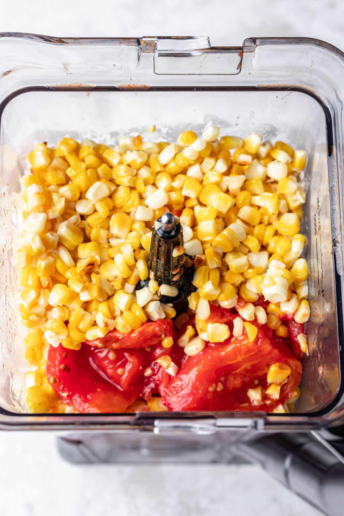 Roast tomatoes and corn in a blender. 