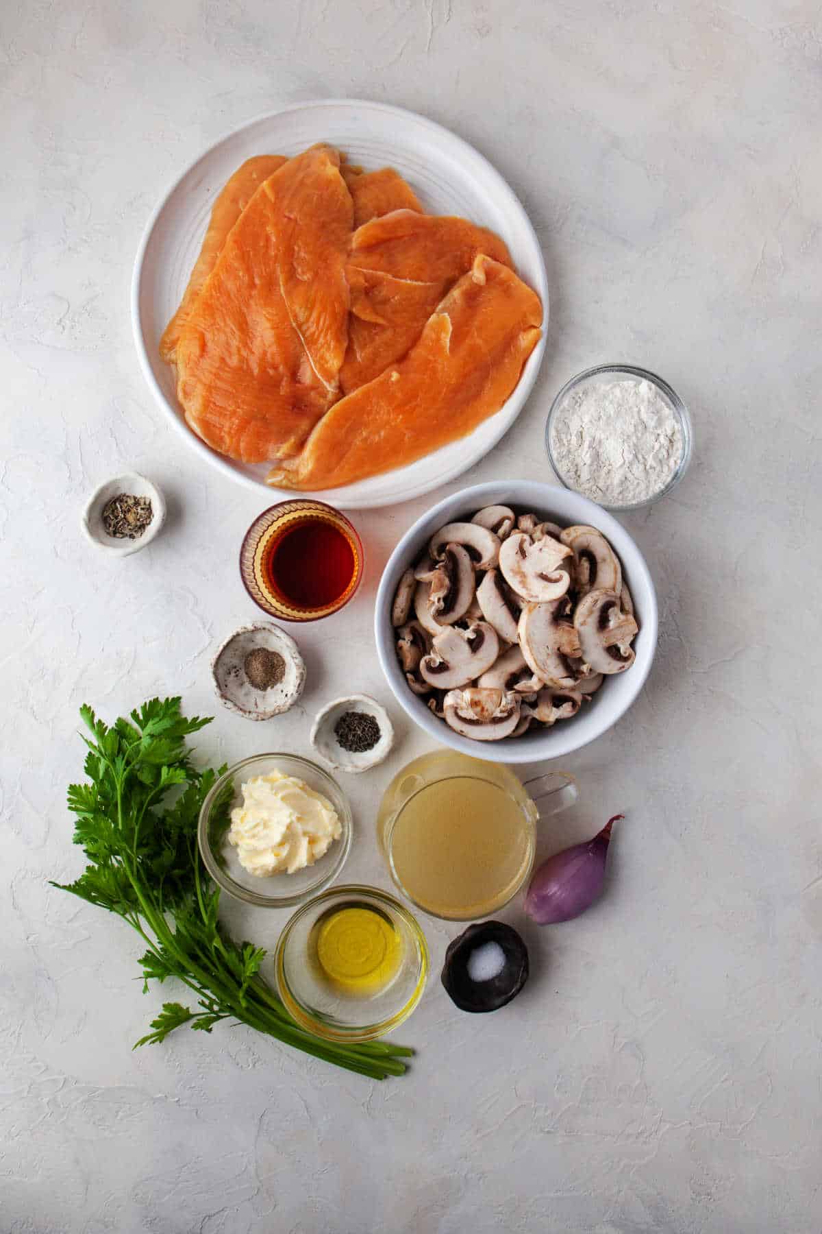 Ingredients for chicken marsala in dishes.