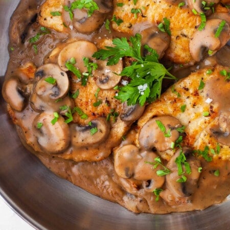 Chicken marsala in a silver skillet.