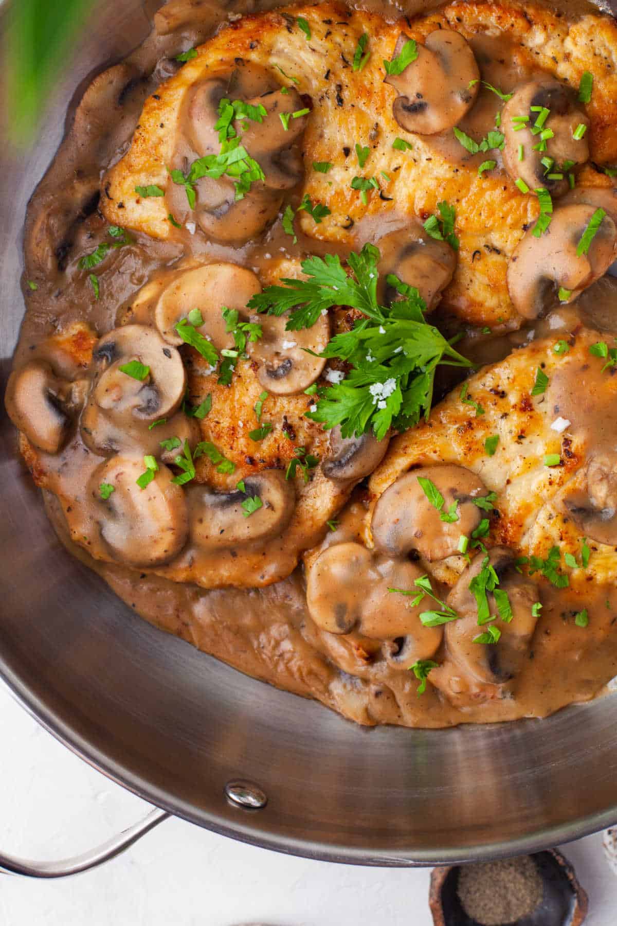 Chicken marsala in a silver skillet.