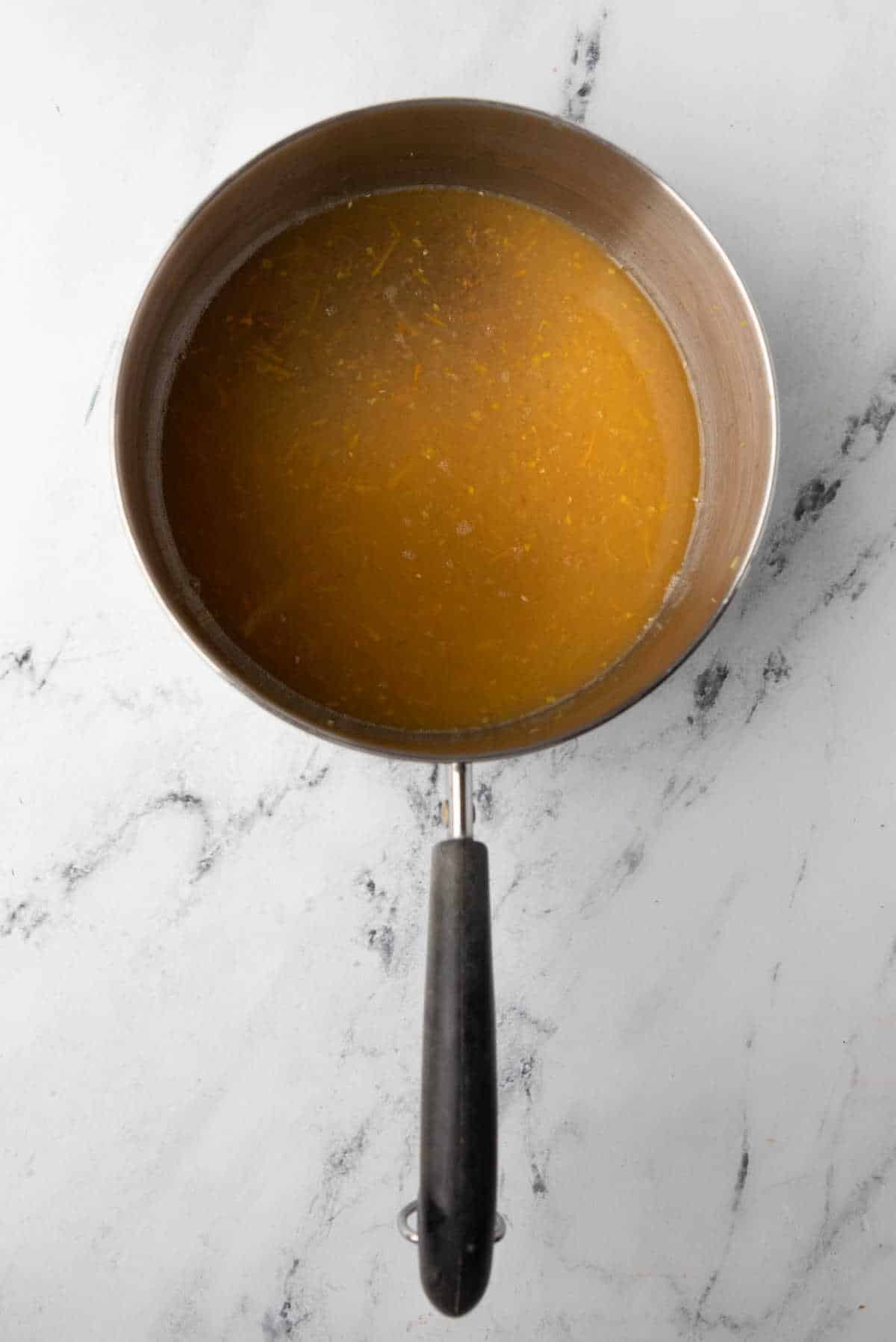 Citrus brown sugar sauce in a saucepan. 