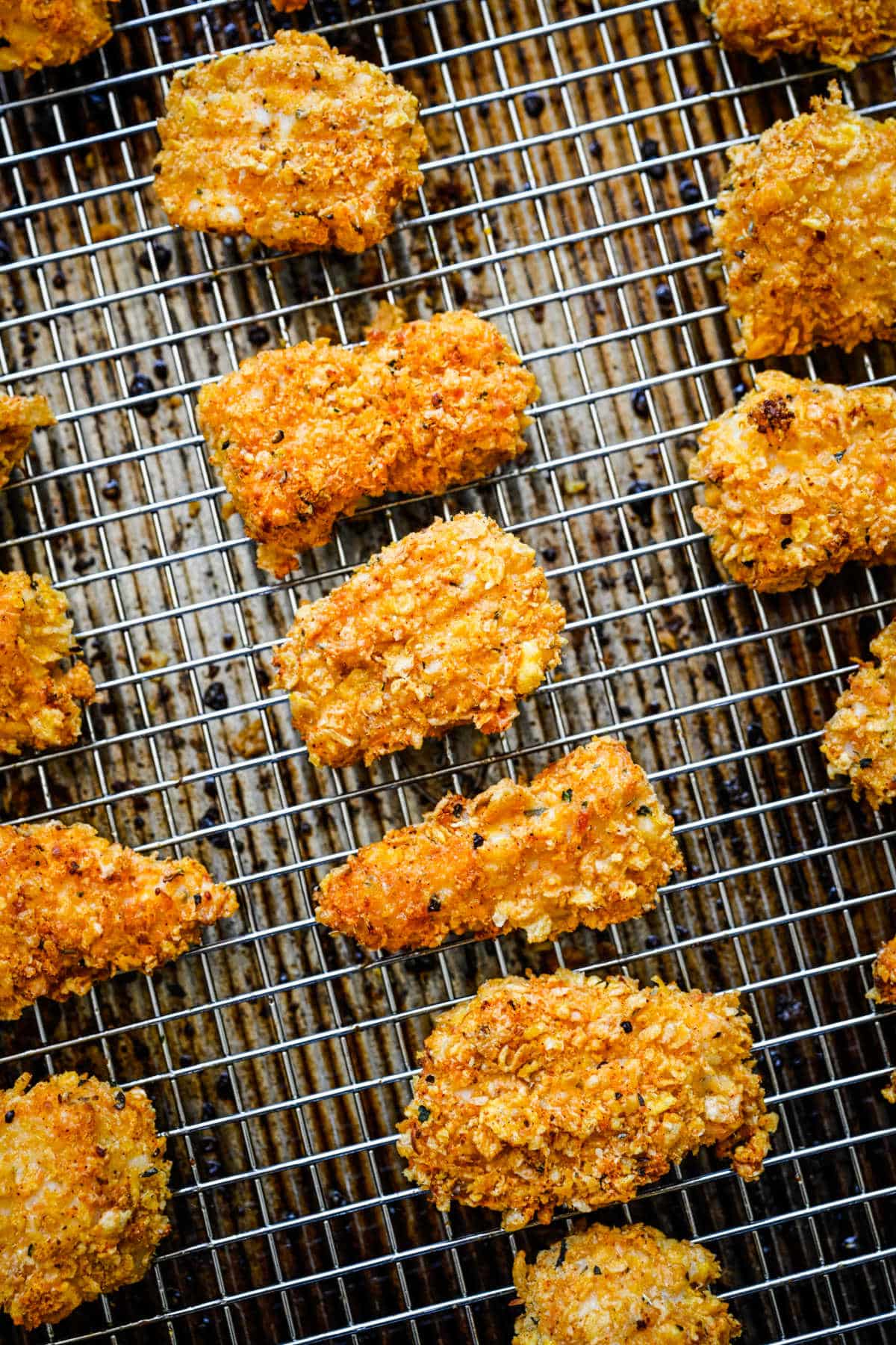 Baked chicken nuggets on a wire cooling rack.