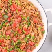 Taco spaghetti in a white skillet.