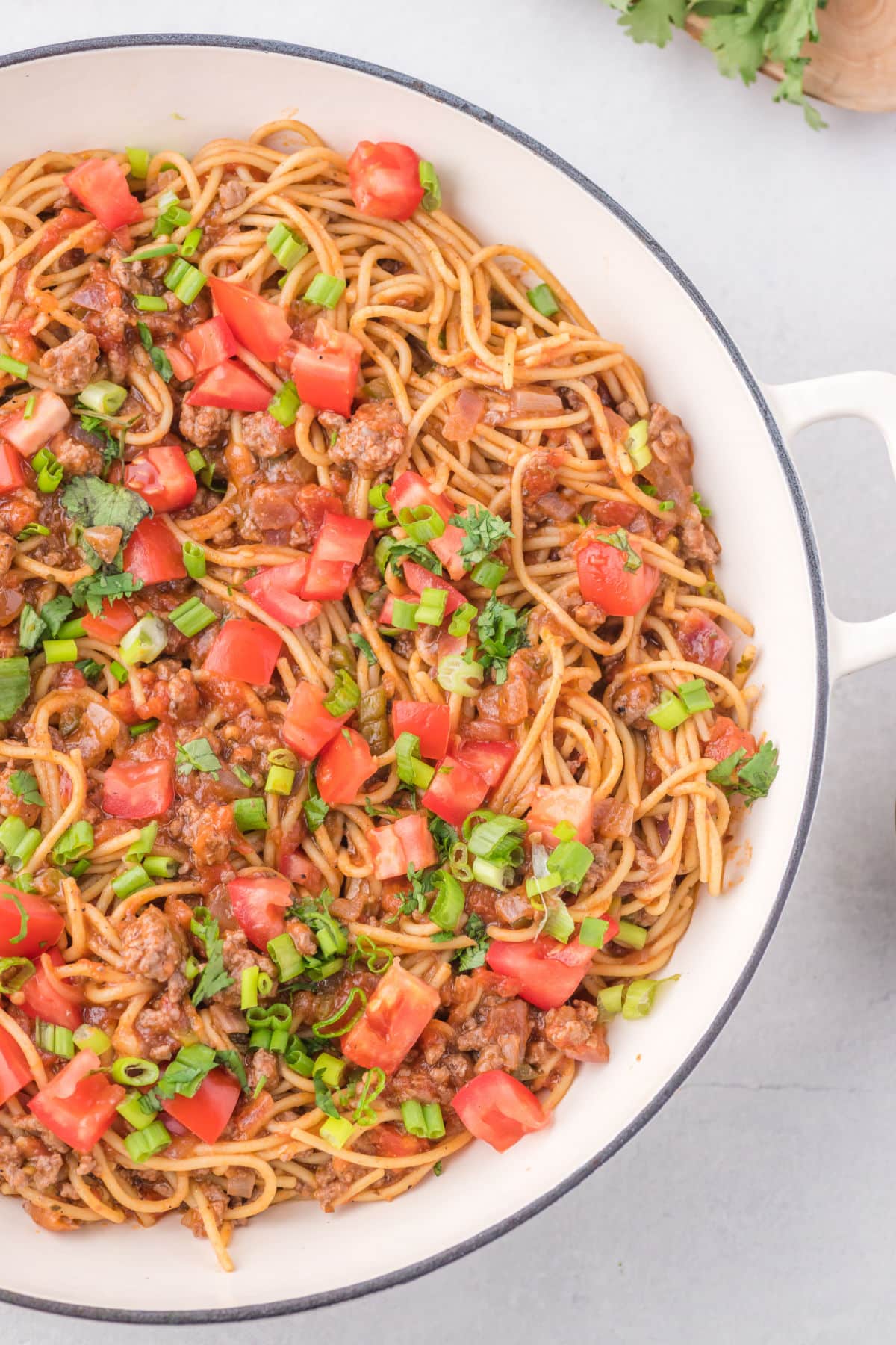 Taco spaghetti in a white skillet.