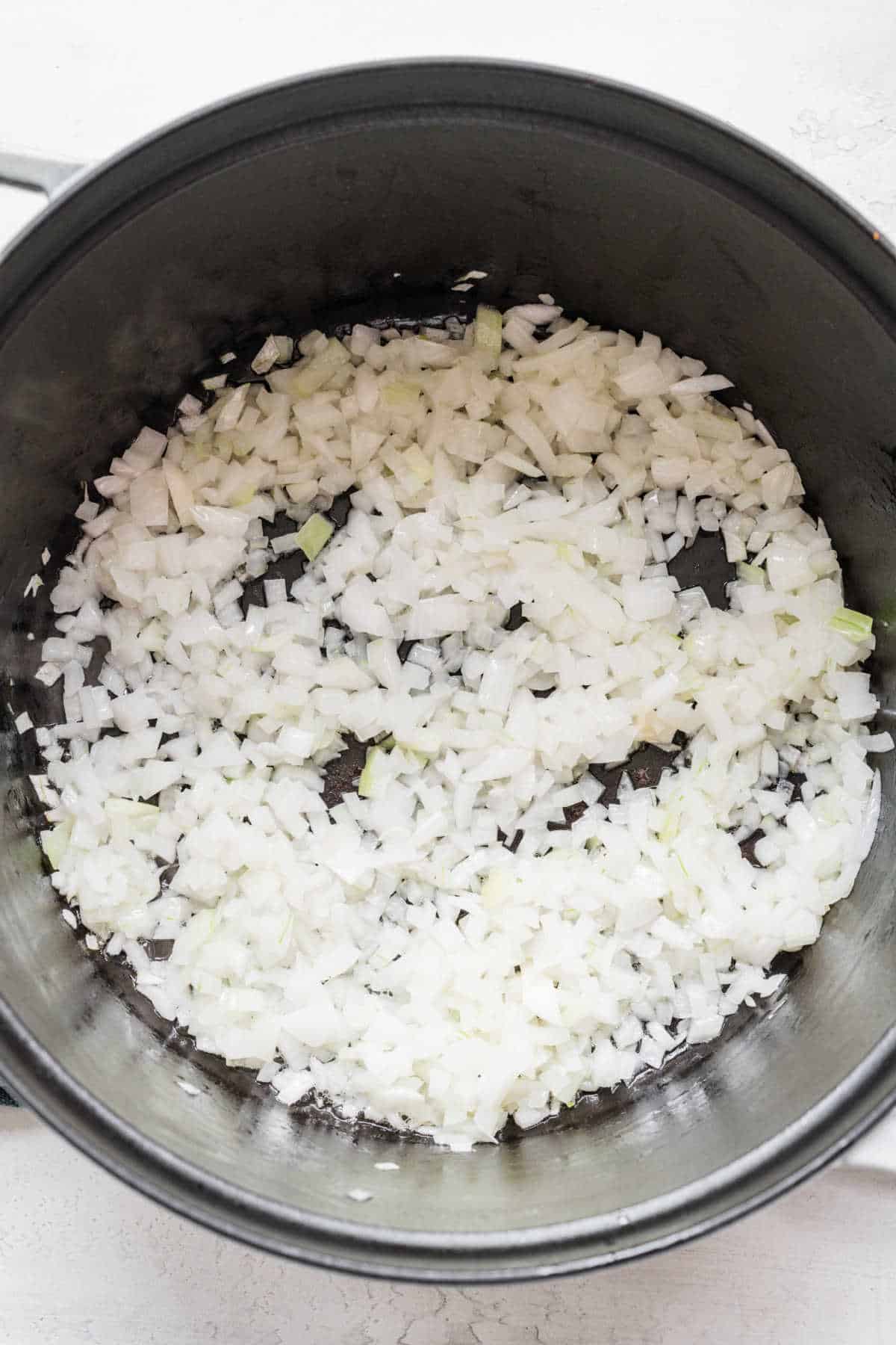 Diced onion cooking in a saucepot. 