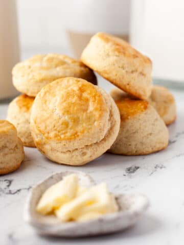 A stack of buttermilk biscuits on a marble background.