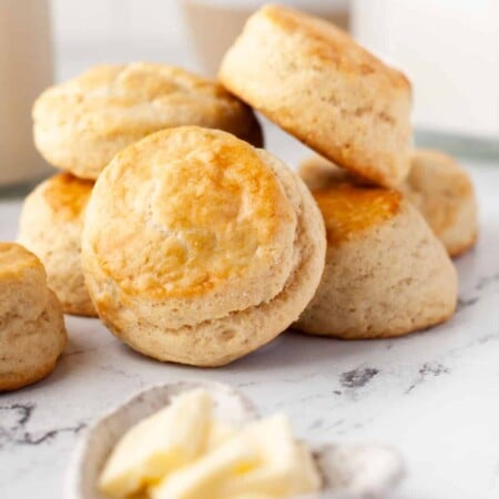 A stack of buttermilk biscuits on a marble background.