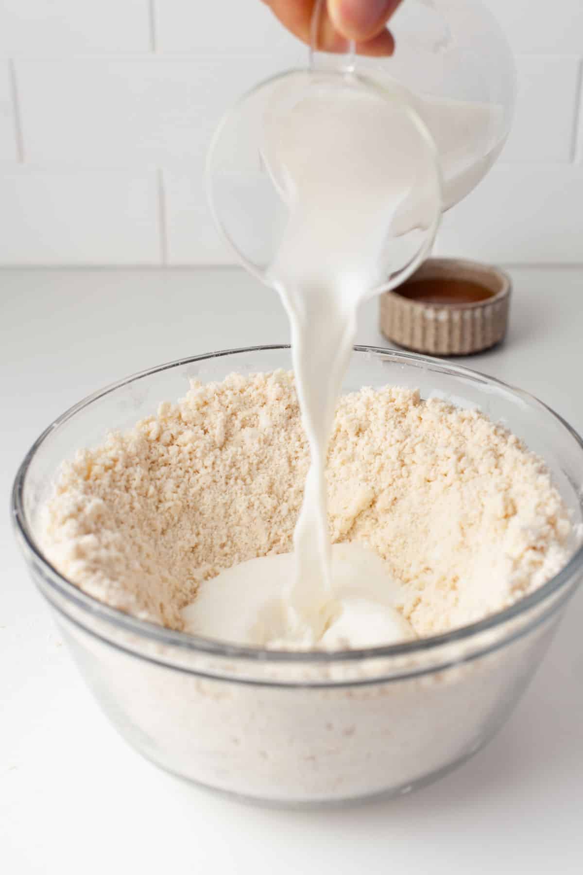 Buttermilk pouring into a bowl.