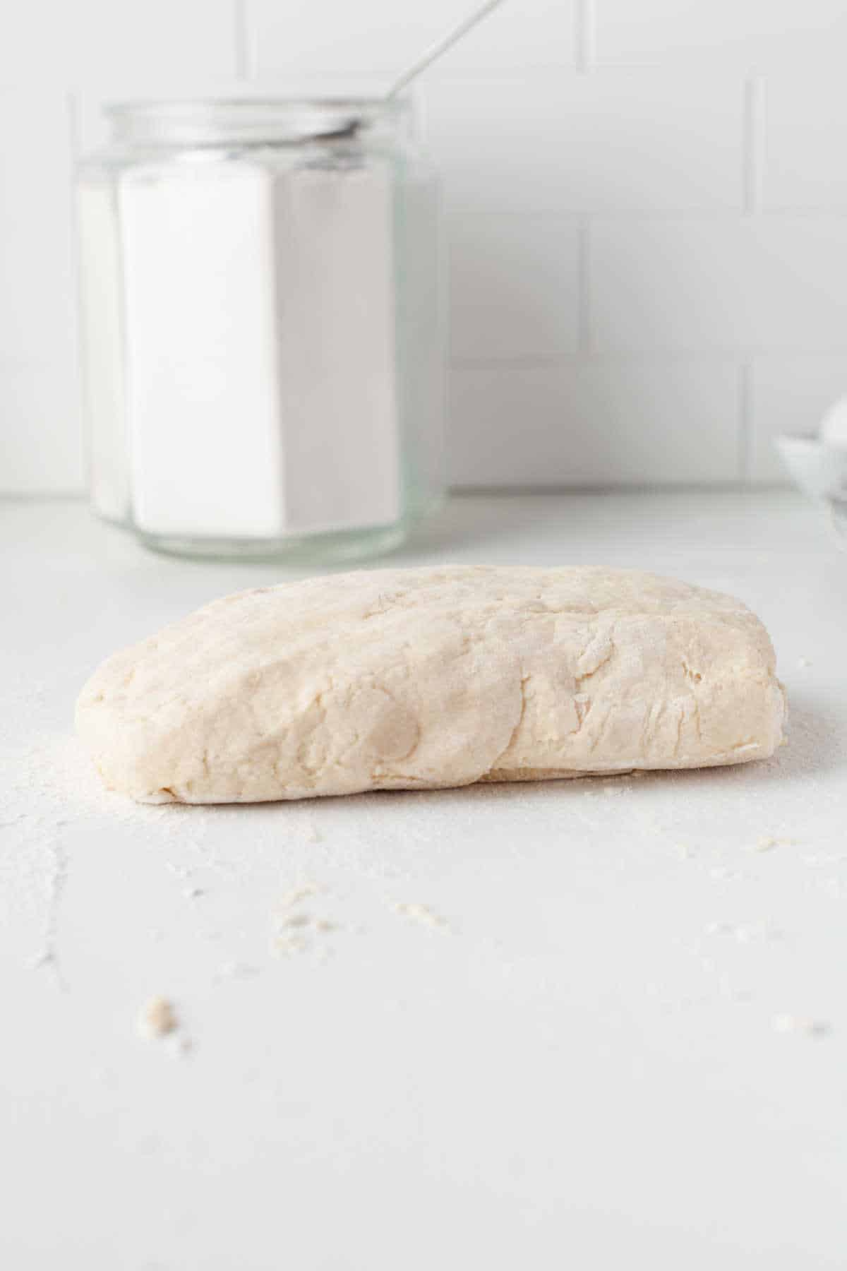 Biscuit dough patted into a rectangle. 