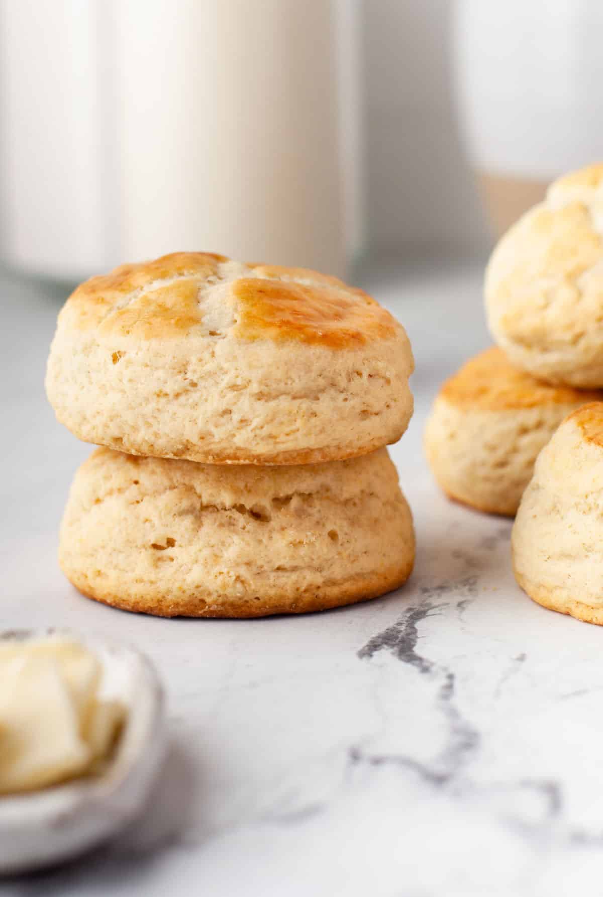 Two buttermilk biscuits stacked on top of each other. 