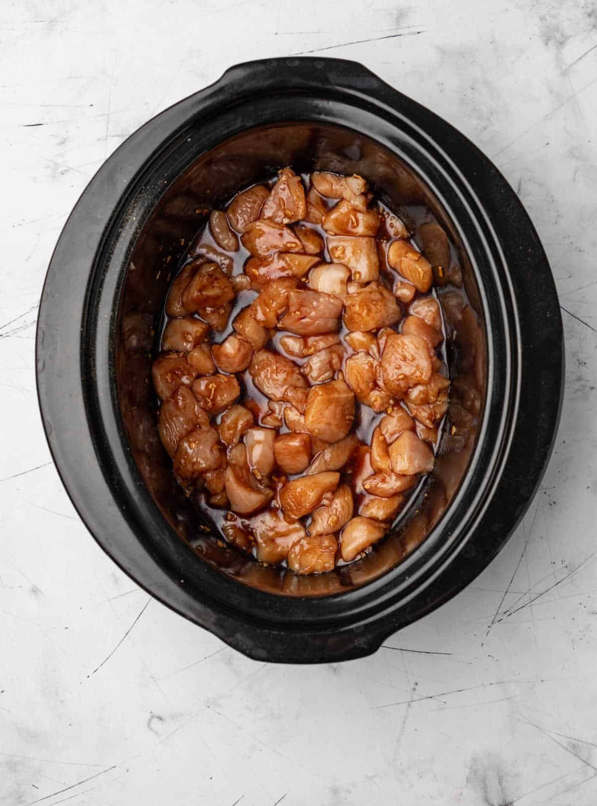 Cut up chicken in sesame chicken sauce in a crock pot. 