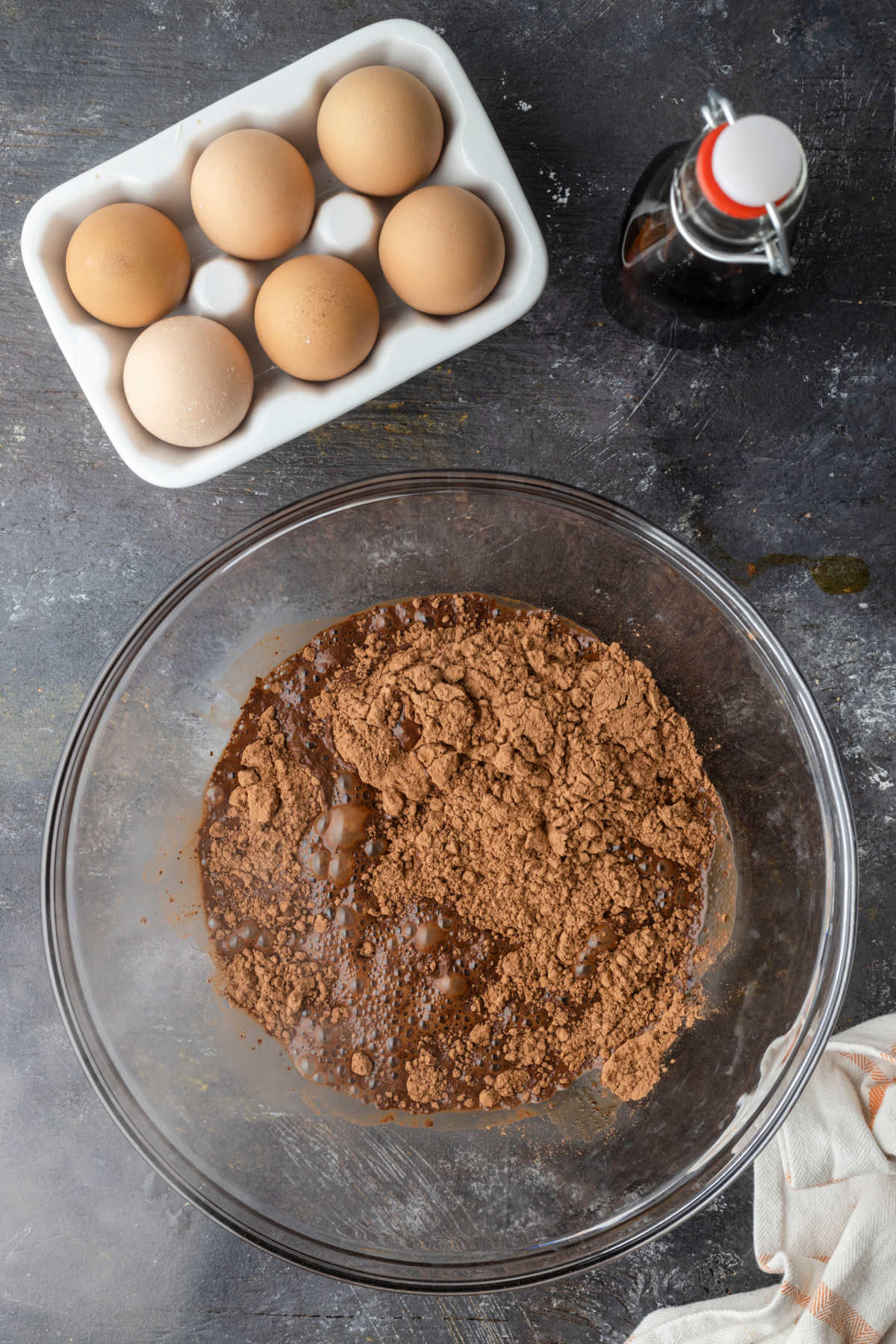 Cocoa powder espresso powder and hot water in a glass mixing bowl. 