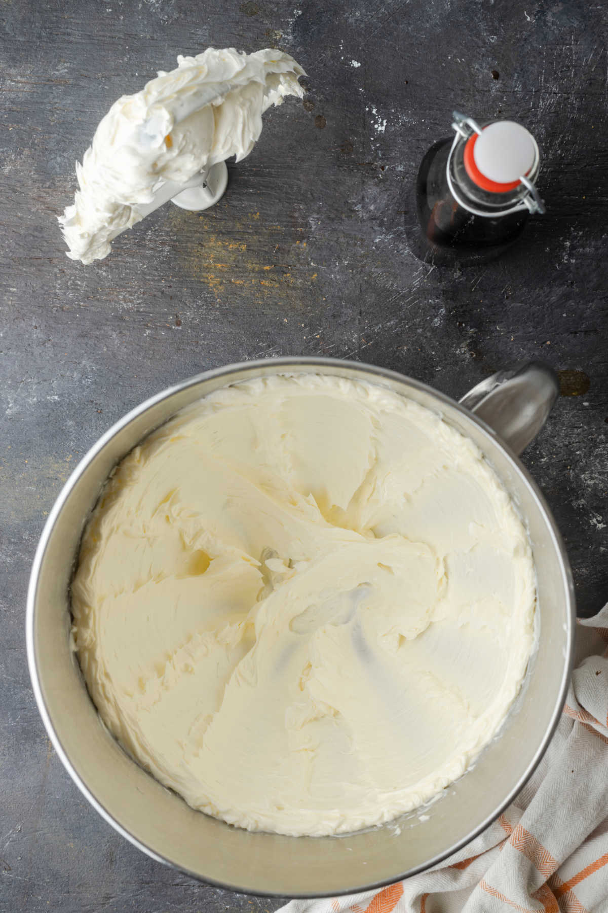 Beaten butter in a silver mixing bowl. 