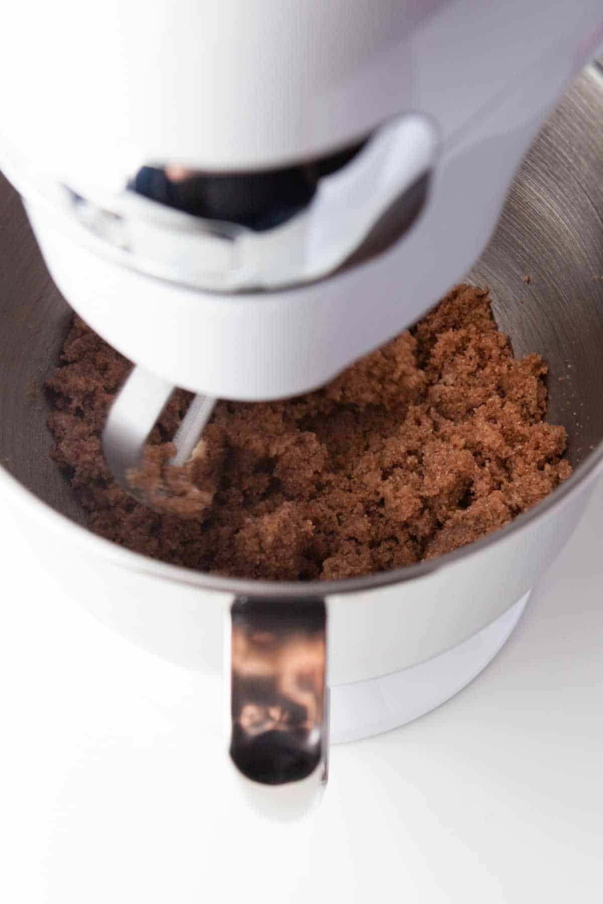 A stand mixer creaming butter and sugars together.
