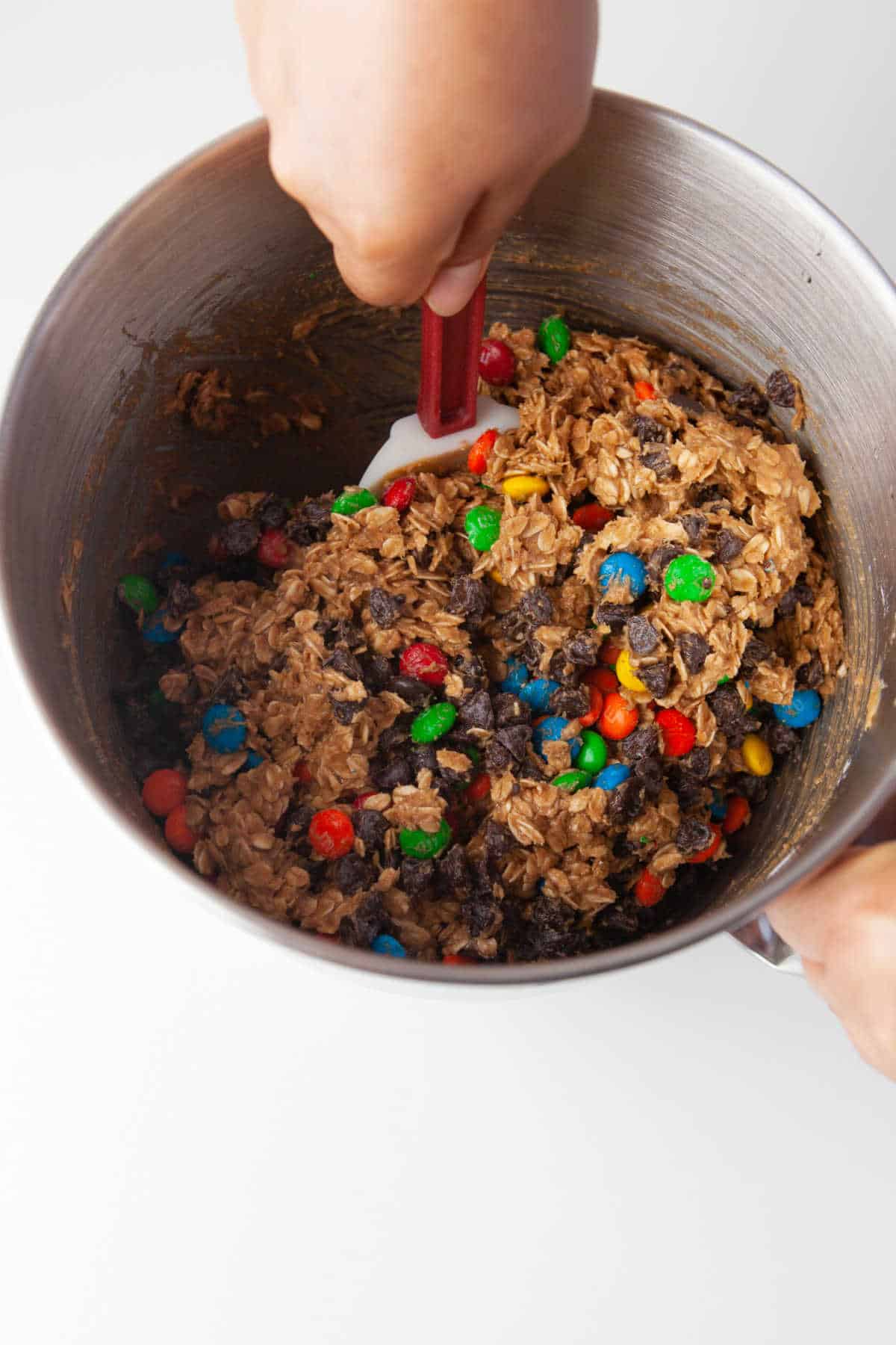A spatula mixing monster cookie dough. 