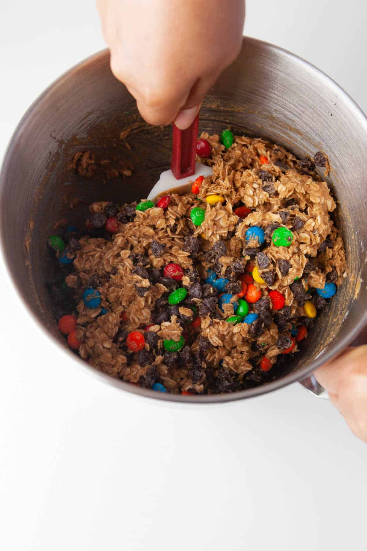 A spatula mixing monster cookie dough.